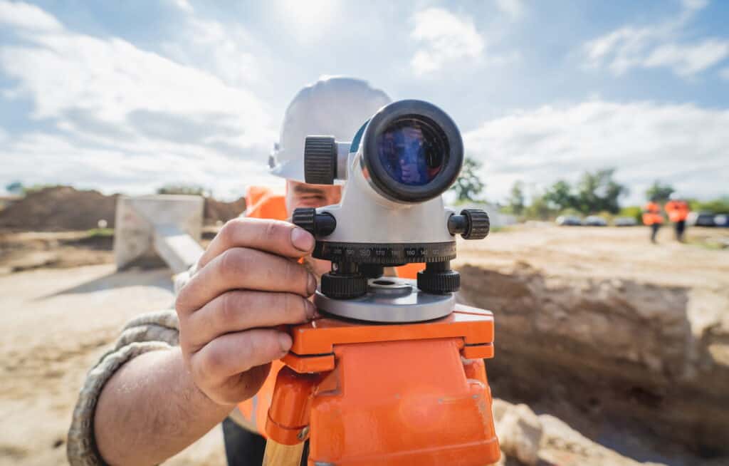 Close up view of man in hi-vis conducting topographical survey