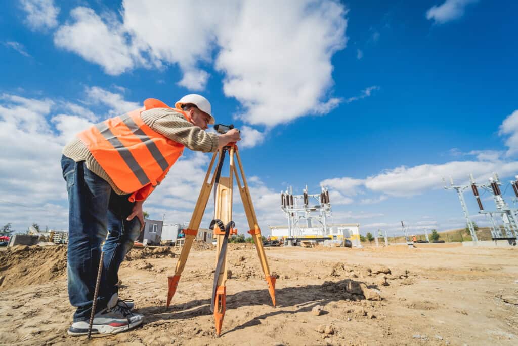 man in hi-vis conducting topographical survey